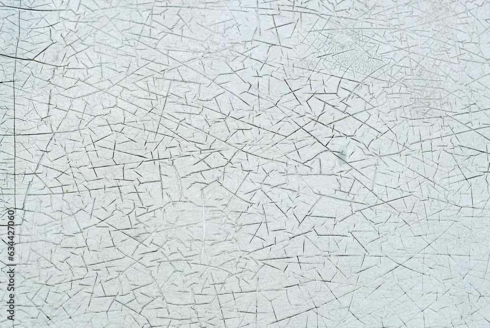 A surface cracked paint on the wall of an old building, abstract texture and background
