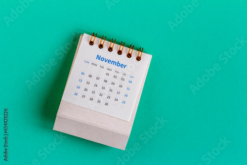 Desk calendar for november 2023 years on the table.