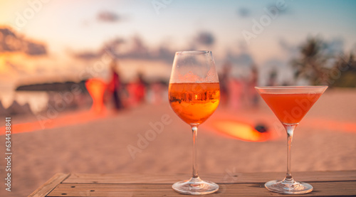 Photography Two cocktail drinks blur beach coast party people and colorful sunset sky in background
