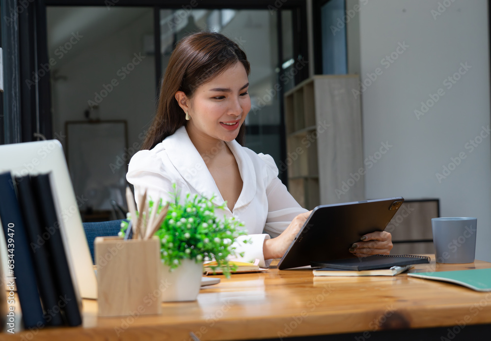 Businesswoman working on laptop in her workstation. Businesswoman working on laptop in her workstation.