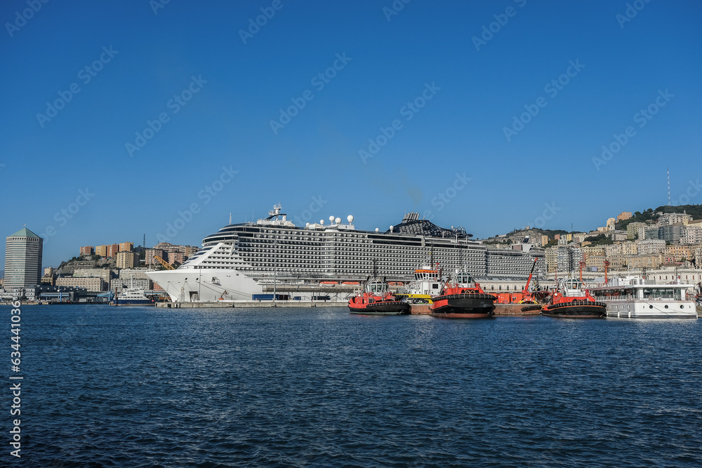 Big modern MSC Cruises cruiseship or cruise ship liner Seaside Seaview in port with downtown Genova Genoa skyline in background waiting for passengers for Mediterranean cruising holiday Big modern MSC Cruises cruiseship or cruise ship liner Seaside Seaview in port with downtown Genova Genoa skyline in background waiting for passengers for Mediterranean cruising holiday