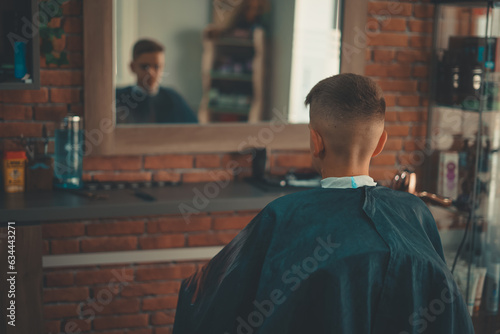 Hairstylist trimming hair of the customer in a beauty salon