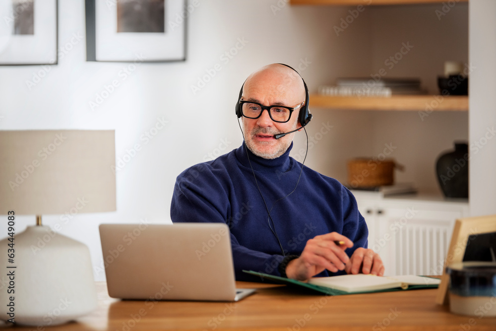 Male customer service assistant business man wearing headset and using laptop for work Male customer service assistant business man wearing headset and using laptop for work