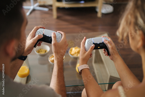 Tableau sur toile First person view of couple using joysticks to play video games on console