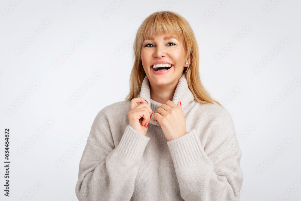 Close-up studio portrait of blond haired mid aged woman agianst isolated background Close-up studio portrait of blond haired mid aged woman agianst isolated background