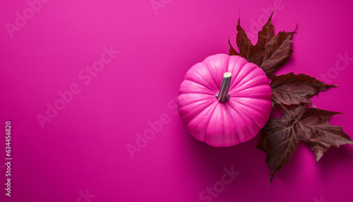 Thanksgiving and Halloween background with pink and magenta pumpkins and fallen leaves in autumn. 