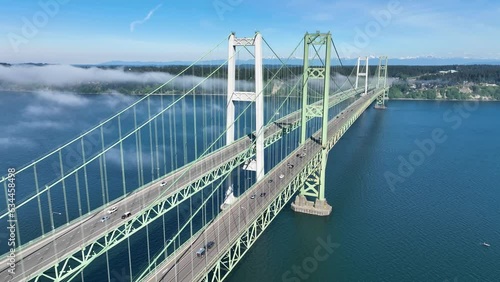 Narrows bridge in Tacoma Washington with the clouds rolling in during a morning sunrise