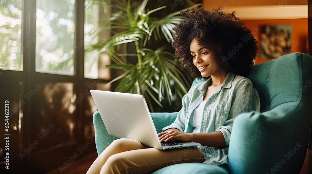 Image of cheerful african american woman using laptop while sitting on chair in living room Generative AI Image of cheerful african american woman using laptop while sitting on chair in living room Generative AI