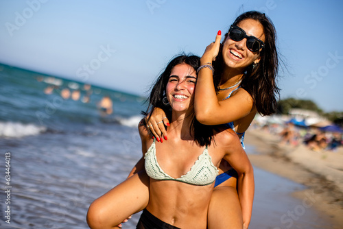 Two pretty young woman having fun on the seaside #634464013