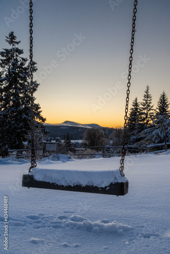 Snowy swing and the evening at Filipova Hut, view on the Roklany mountains in the background