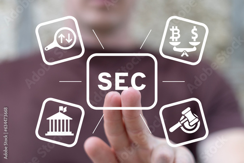 Man using virtual touch screen presses acronym: SEC. Concept of Security Exchange Committee (SEC). SEC exercises control of Exchange Traded Fund (ETF). photo