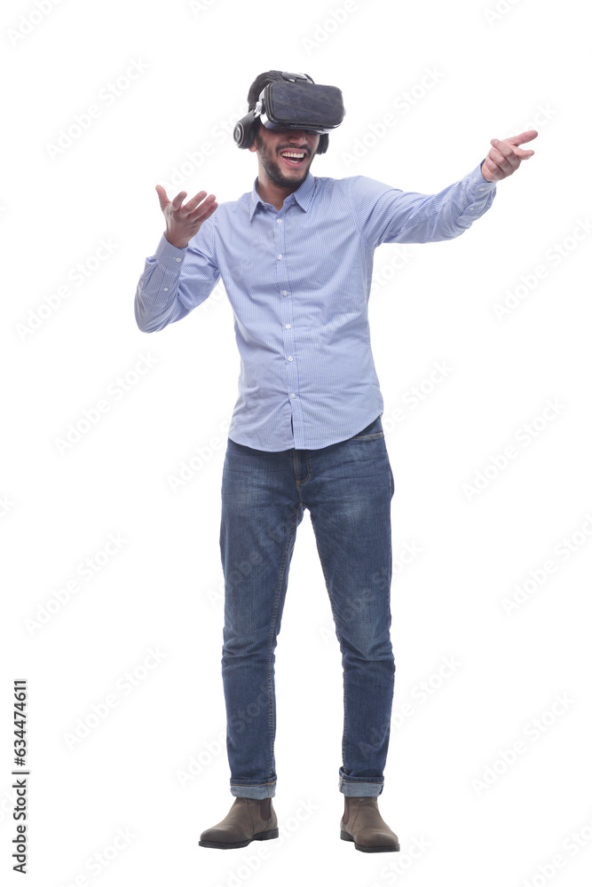 in full growth. smiling young man wearing virtual reality glasses. in full growth. smiling young man wearing virtual reality glasses.