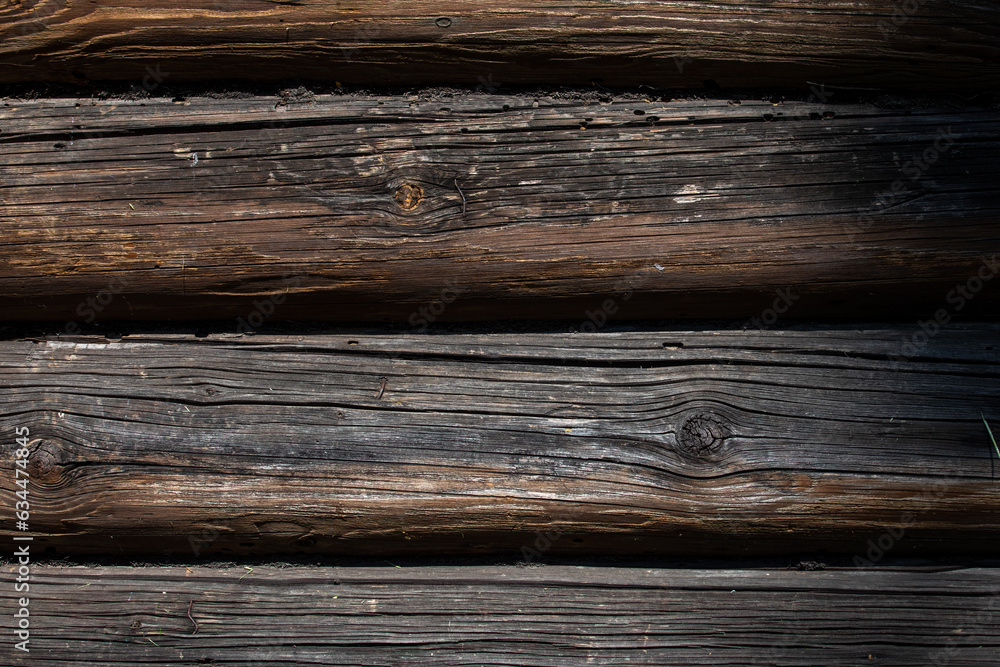 Fototapeta premium Wooden logs of an old house. The background is made of natural wood.