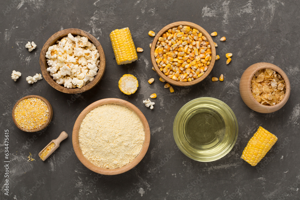 Maize products with fresh corn cobs on concrete background, top view