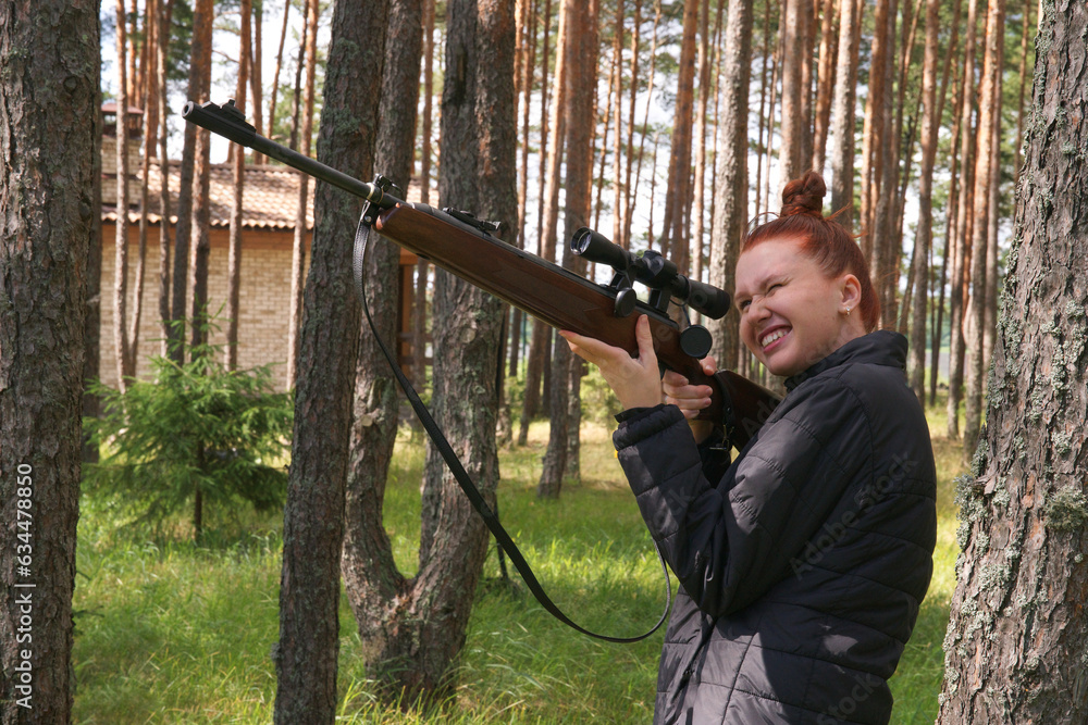 young-redhead-woman-protecting-her-house-or-on-tactical-gun-training