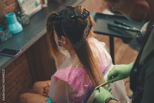 Detailed shot of a hairdresser working on his client's hair in a vintage store and working by hand