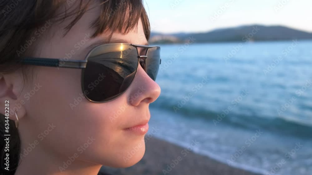 Teen enjoy morning sea during traveling. A young traveler stay on the beach and look at the sea distance in the day light in summer. Teen enjoy morning sea during traveling. A young traveler stay on the beach and look at the sea distance in the day light in summer.