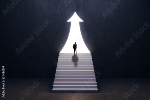 Back view of businessman silhouette in abstract concrete interior with upward arrow opening and stairs. Success, financial growth and future concept.