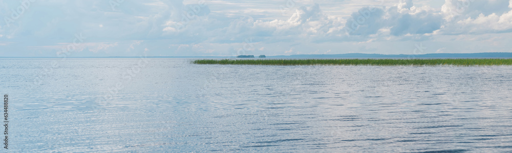 natural landscape, wide lake with reed banks and distant shoreline