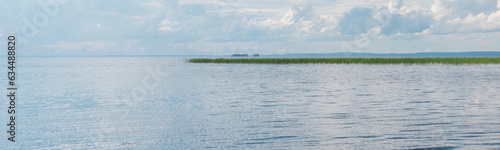 natural landscape, wide lake with reed banks and distant shoreline