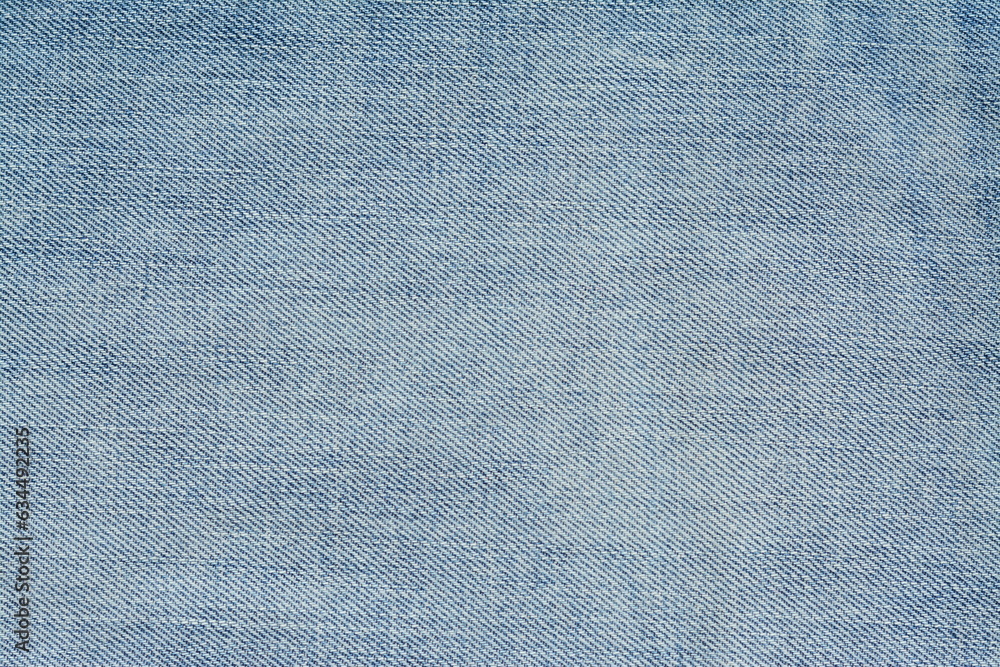 Background of washed light blue jeans. View from above Background of washed light blue jeans. View from above