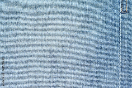 Background of washed light blue jeans with a seam. View from above