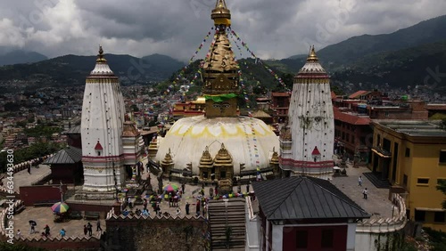 Aerial view of the popular Tibetan pilgrimage temple Swayambhu in Kathmandu city. Drone flight with a view of Buddha's eyes in Swayambhunath. Cinematic 4k footage. photo