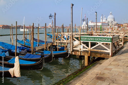 Gondolas at the dock in the grand canal in venice italy, ready for service