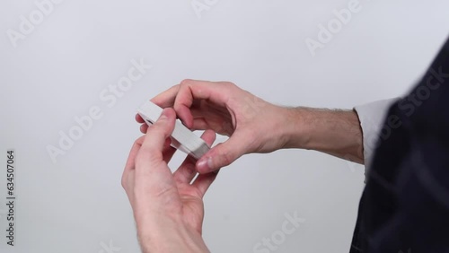 The croupier, the magician, shows a trick with playing cards
