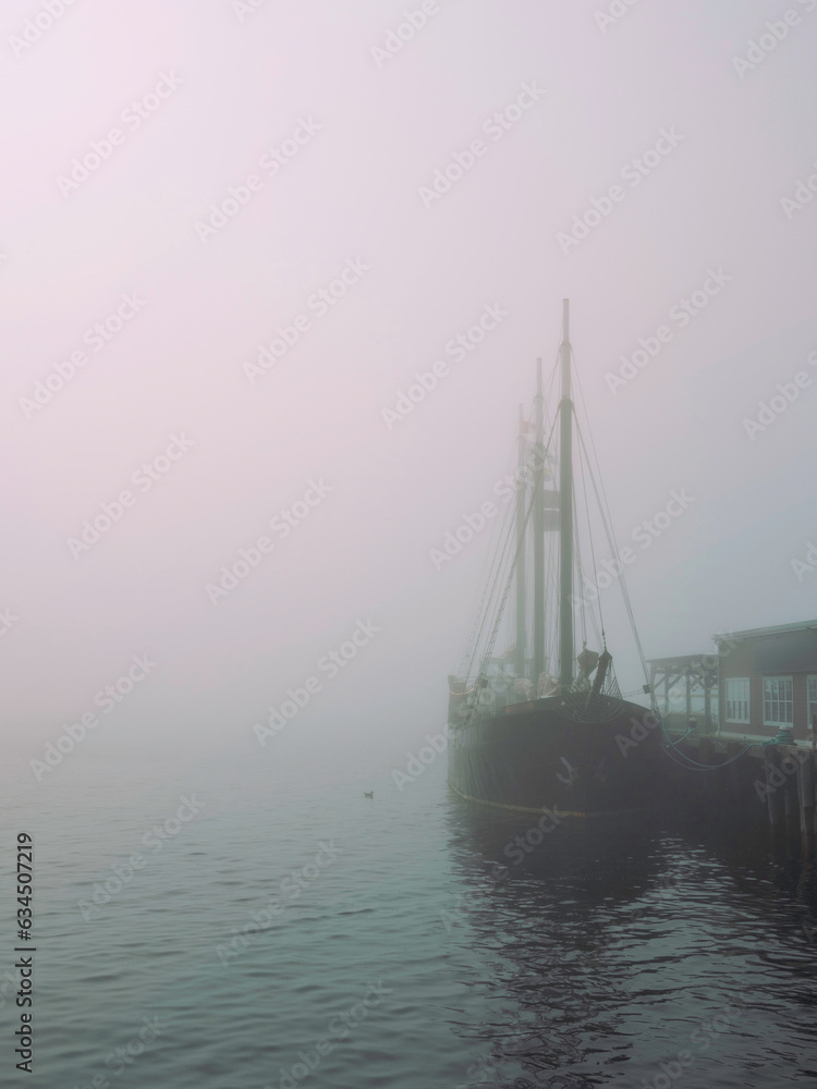 Fototapeta premium Halifax Harbor foggy morning with a moored boat in Nova Scotia,