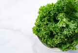 Kale in bowl on marble background. curly kale.