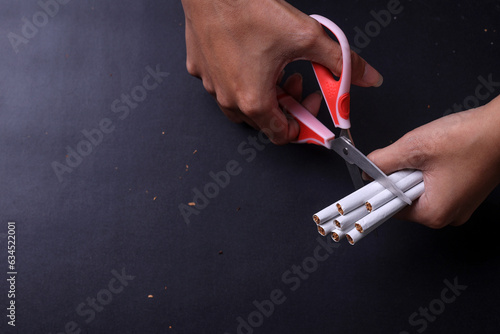 Close up of scissors cutting many cigarettes. Concept of anti smoking, stop smoking and no tobacco day