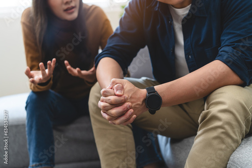 Fotografie Family problem concept, Close-up hands of Asian wife sitting on sofa and husband