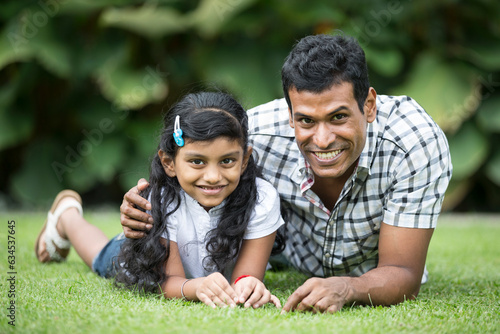 Happy Indian dad and his child playing outdoors