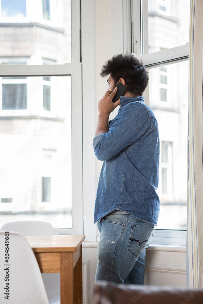 Indian Man using his phone at home. Indian Man using his phone at home.