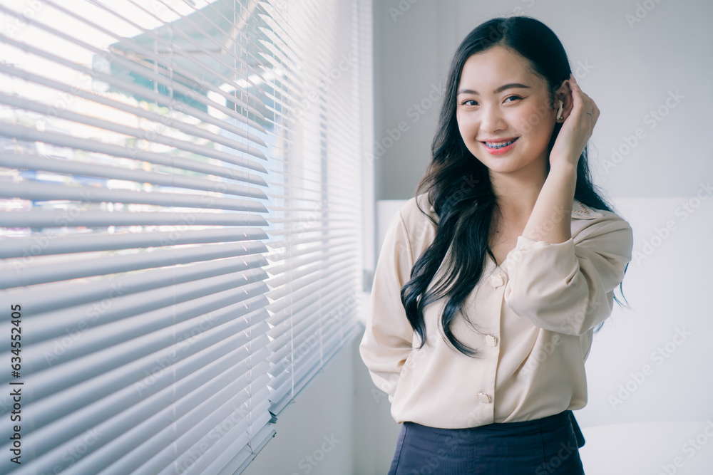 Portrait of young asian woman smiling with arms crossed. Modern business asian woman. Successful businesswoman standing in office with copy space. Portrait of young asian woman smiling with arms crossed. Modern business asian woman. Successful businesswoman standing in office with copy space.