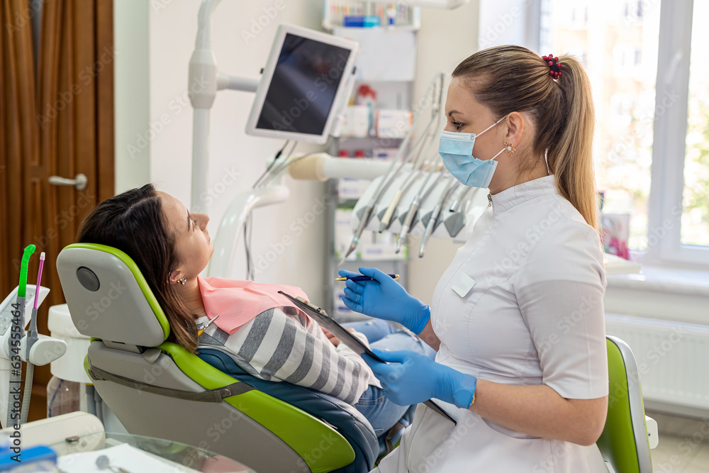 Female patient receives a professional consultation at a dentist clinic
