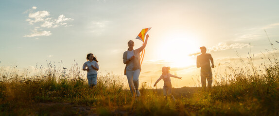 Happy family at sunset