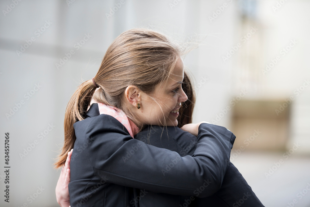 Two Businesswomen hugging each other. Two Businesswomen hugging each other.
