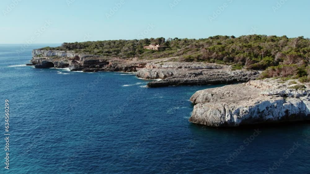 Calm And Blue Sea With Rocky Shore In Cala Mondragó Beach, Mallorca, Spain. Aerial Shot
