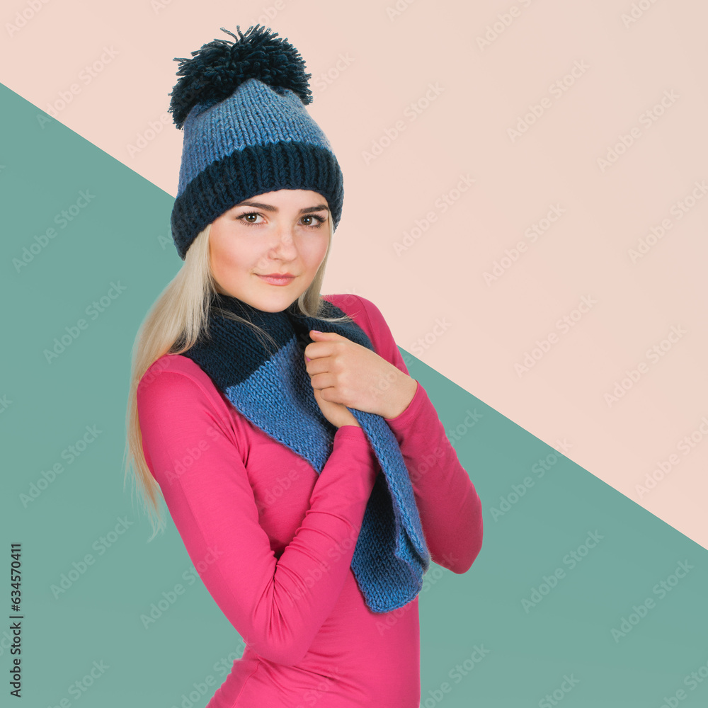 Pretty blonde woman in winter cap wrapped in knitted scarf to warm herself Pretty blonde woman in winter cap wrapped in knitted scarf to warm herself