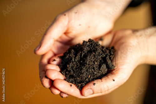 Female soil scientist holding a soil in a hand in a soil laboratory in australia