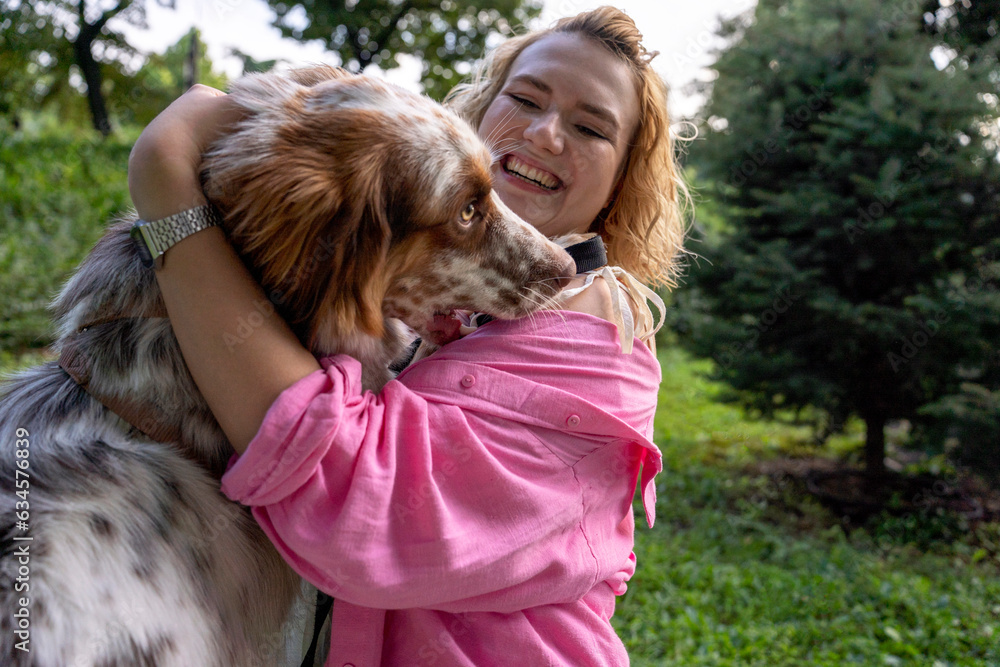 Smiling woman hugging dog in park Smiling woman hugging dog in park