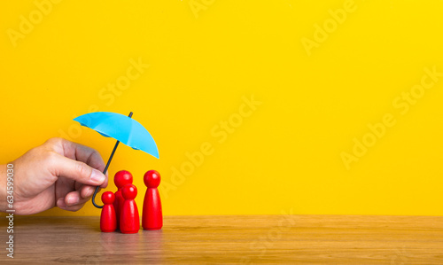 Billede på lærred Hand holding umbrella and cover family.