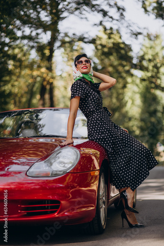 Beautiful woman driving red cabrio © Petro