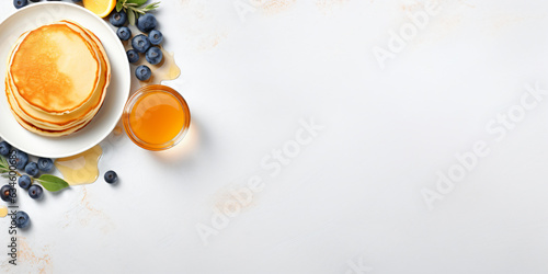 Plate of tasty pancakes with blueberries and honey on light grey table, flat lay with space for text. Banner design - Generative AI