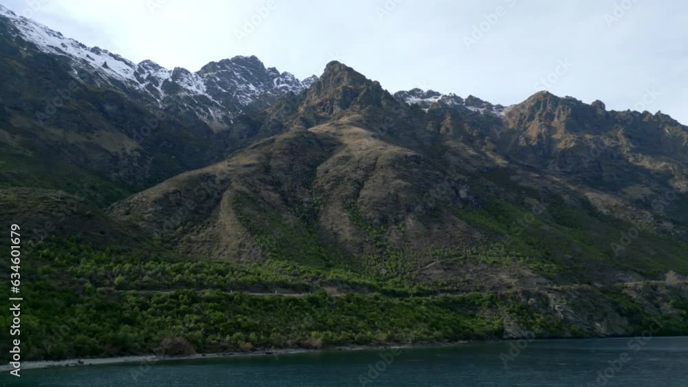 Tilting panning drone shot of Queenstown mountains Tilting panning drone shot of Queenstown mountains