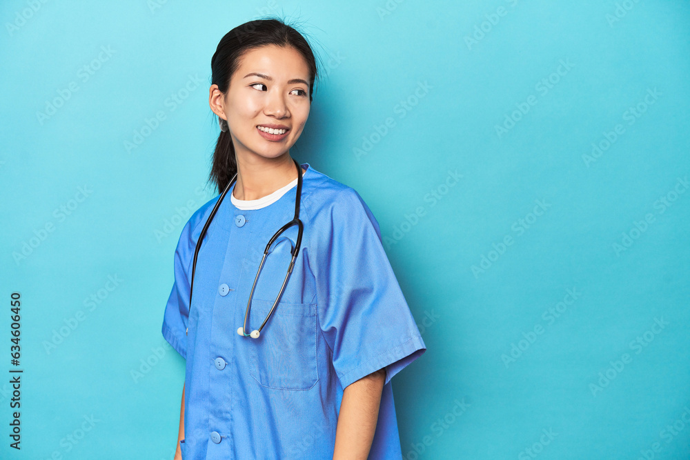 Asian nurse with stethoscope, medical studio shot, looks aside smiling, cheerful and pleasant. Asian nurse with stethoscope, medical studio shot, looks aside smiling, cheerful and pleasant.
