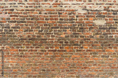 Old red brick wall with different shades. Texture of a brick wall