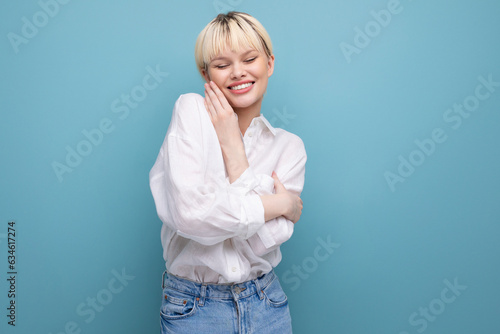 portrait of a young blond business woman with a short haircut in a white shirt on a background with copy space